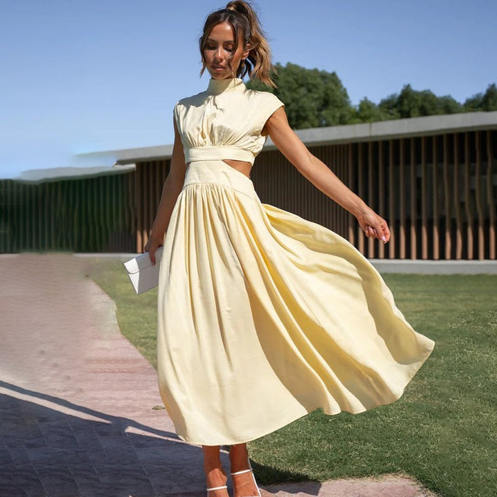 Pale yellow cut-out midi dress with cap sleeves flowing in motion