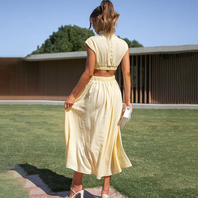 Rear view of pale yellow midi dress with pleated flared skirt