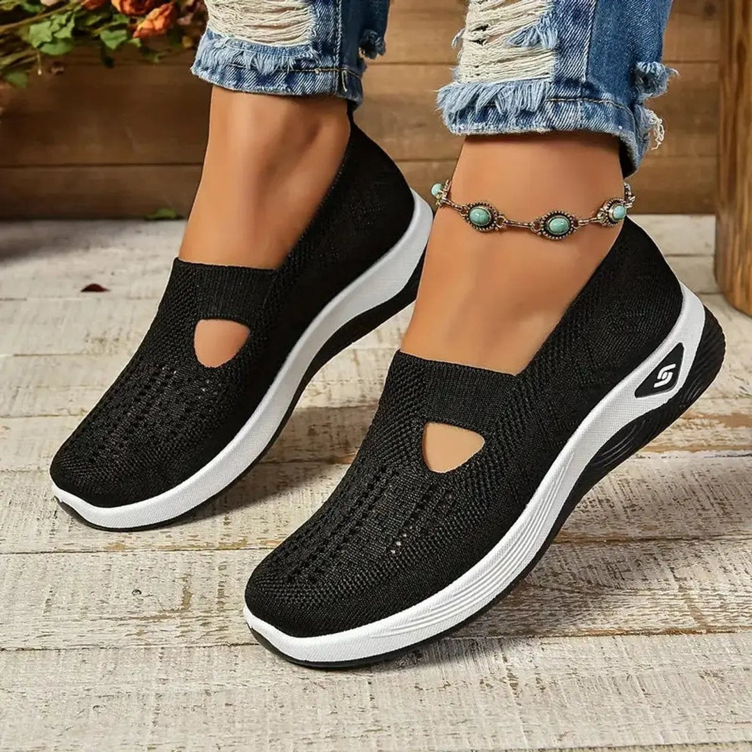 Black mesh slip-on trainers with cut-out detail and contrasting white sole