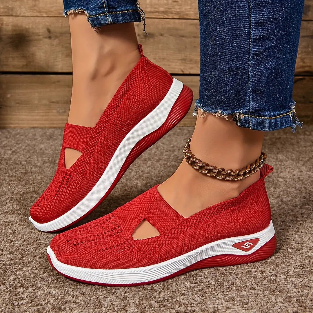 Red knitted slip-on trainers featuring cut-out design and white platform sole