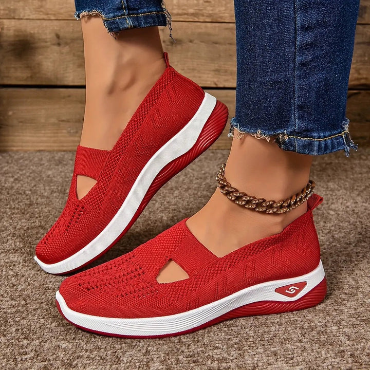 Red knitted slip-on trainers featuring cut-out design and white platform sole