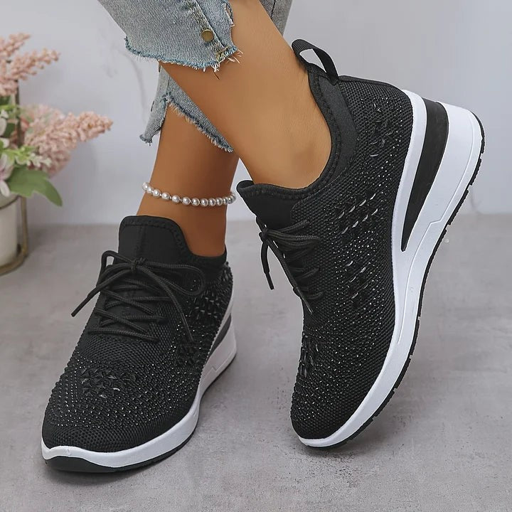Black knitted trainers featuring diamante star patterning and white sole