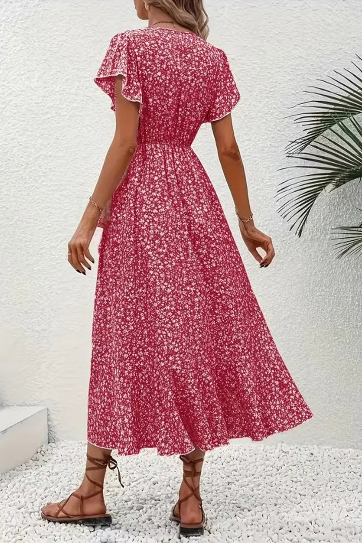 Back view of red floral wrap dress showing ruffled hem and slim waist