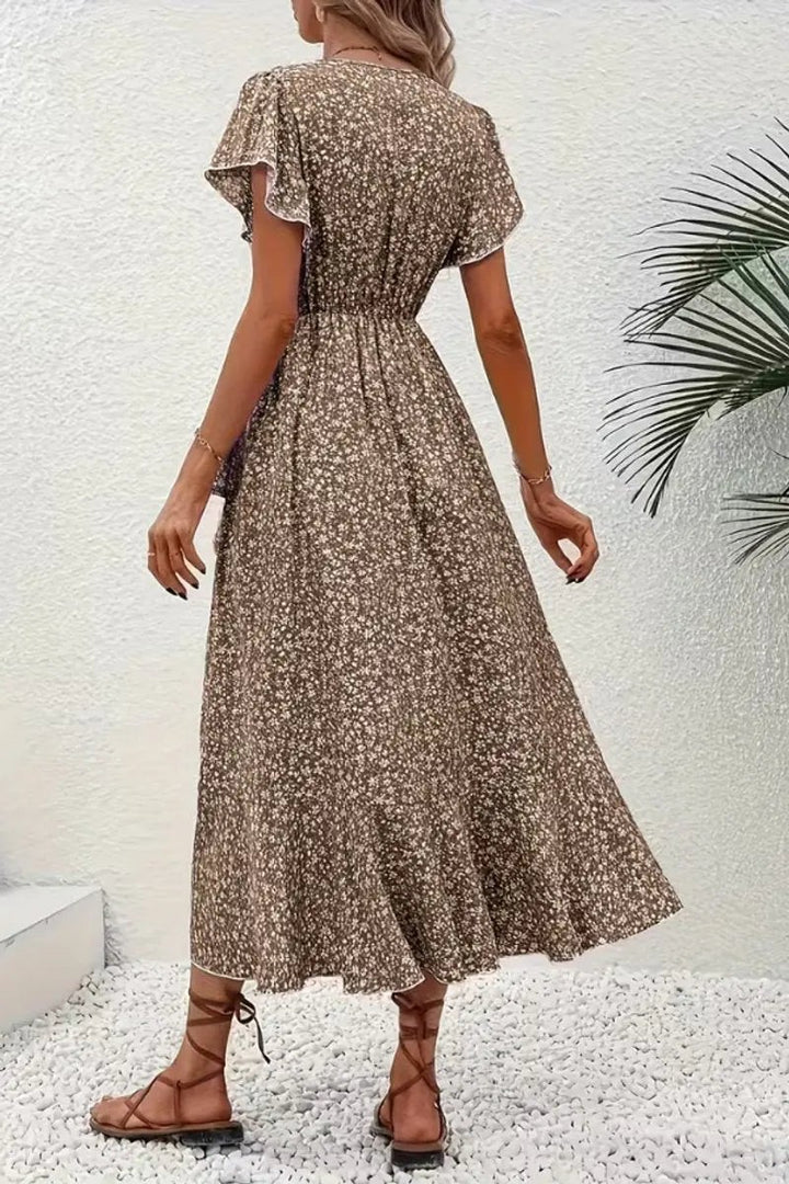 Rear view of brown floral wrap midi dress showing flowing ruffled hemline