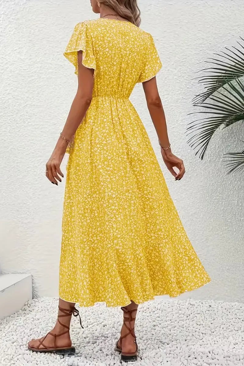 Rear view of yellow floral wrap dress showing elasticated waist and flare