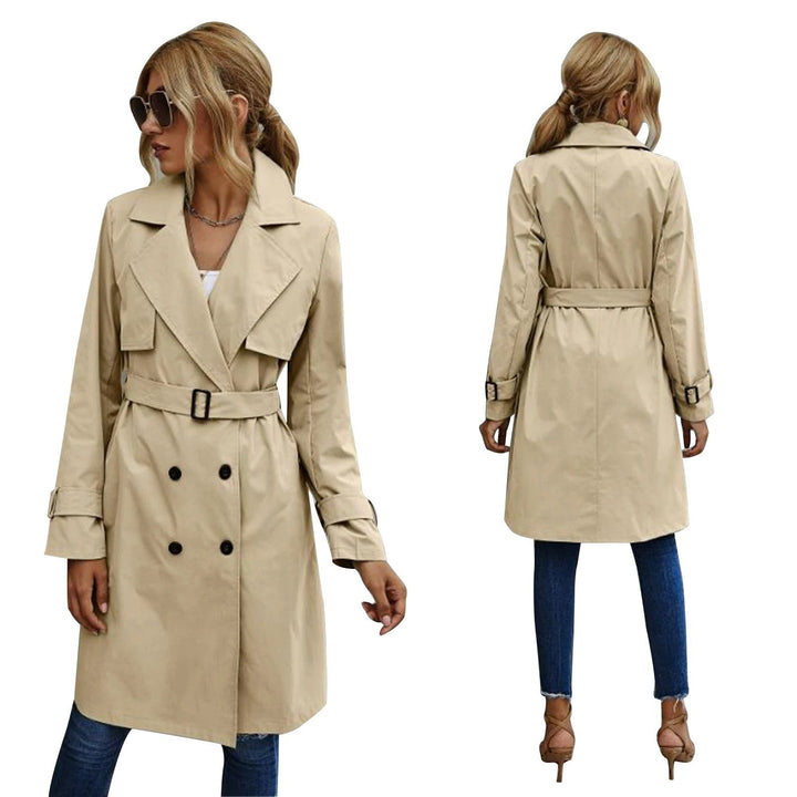 Beige double-breasted trench coat featuring belted waist and buckle cuffs