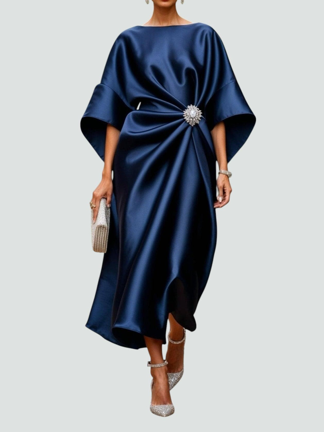 Navy satin midi dress with draped waist and jewelled brooch detail