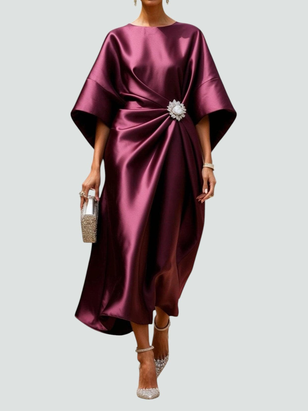 Wine-coloured satin kaftan dress featuring ruched waist and diamante clasp