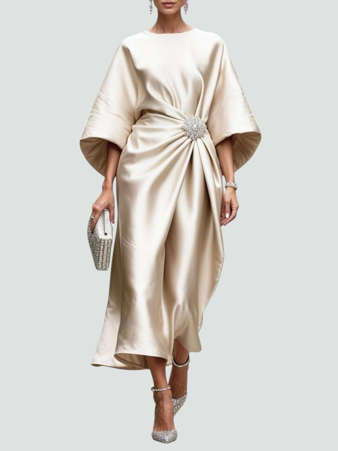 Champagne satin midi dress with gathered waist and crystal brooch feature