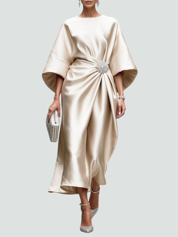 Champagne satin midi dress with gathered waist and crystal brooch feature