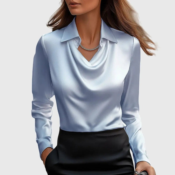 Pale blue satin blouse showing draped neckline and glossy sheen, teamed with black skirt