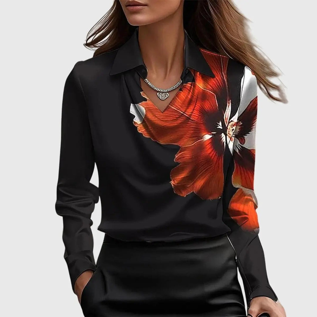 Black satin blouse with bold orange floral print across one shoulder and collar