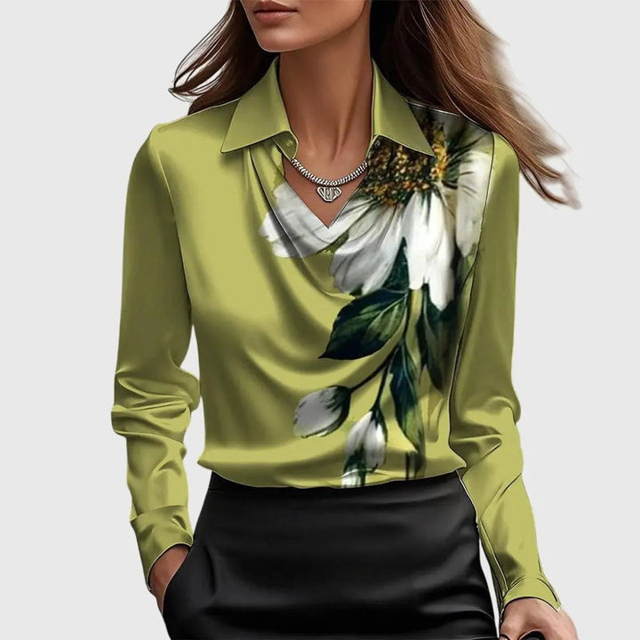 Olive green satin blouse featuring a large white floral print at the shoulder