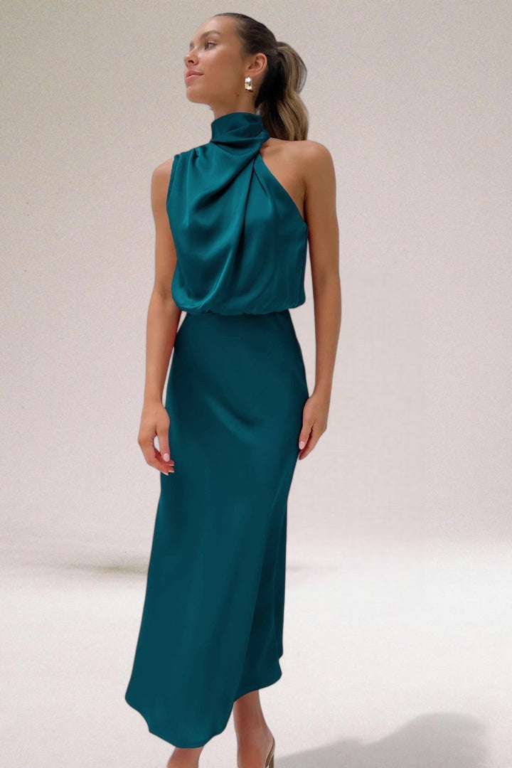 Teal satin halter dress featuring draped neckline and blouson bodice