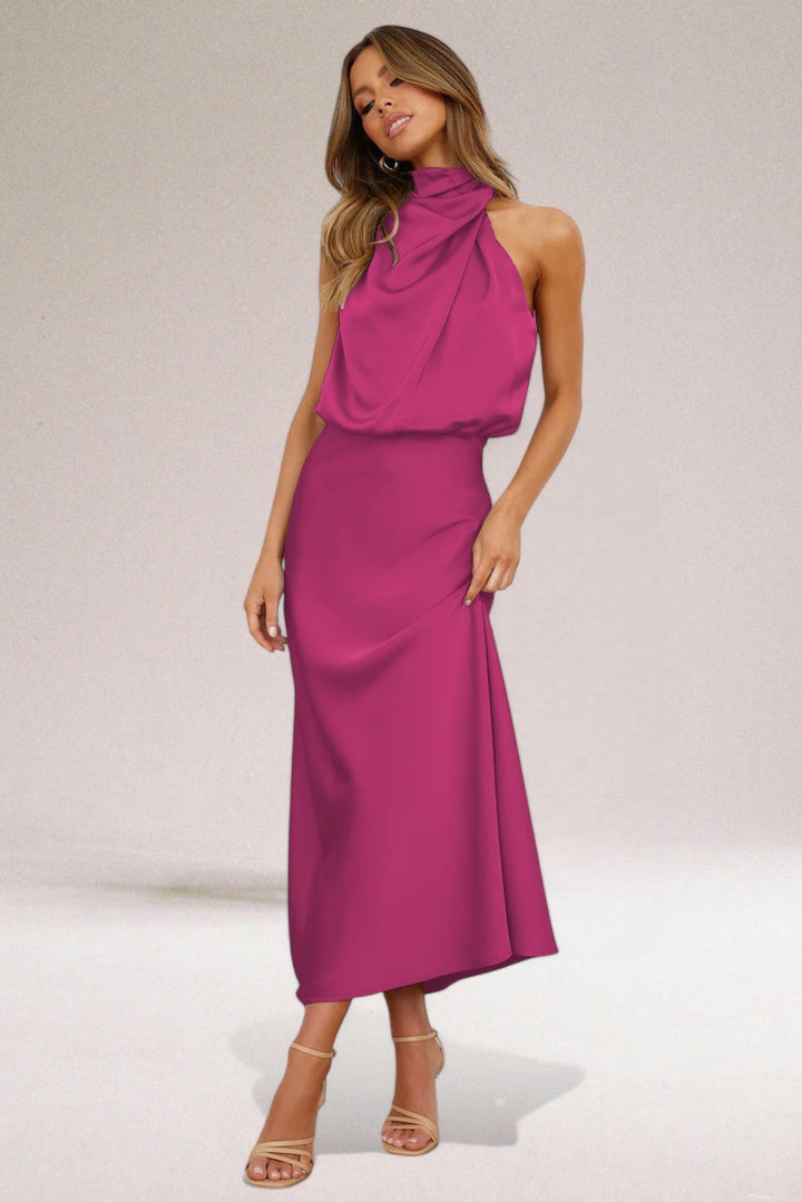 Magenta satin halter dress showcasing draped neck and fitted skirt