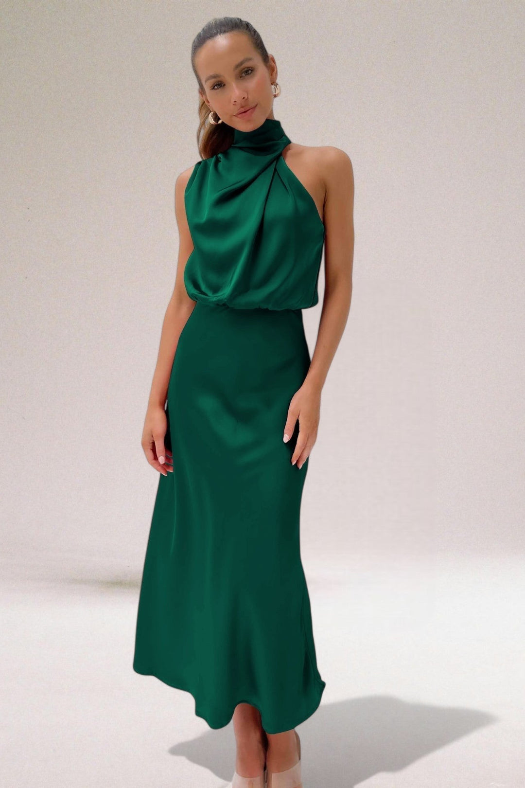 Emerald green satin halter dress with cowl neckline and flowing skirt