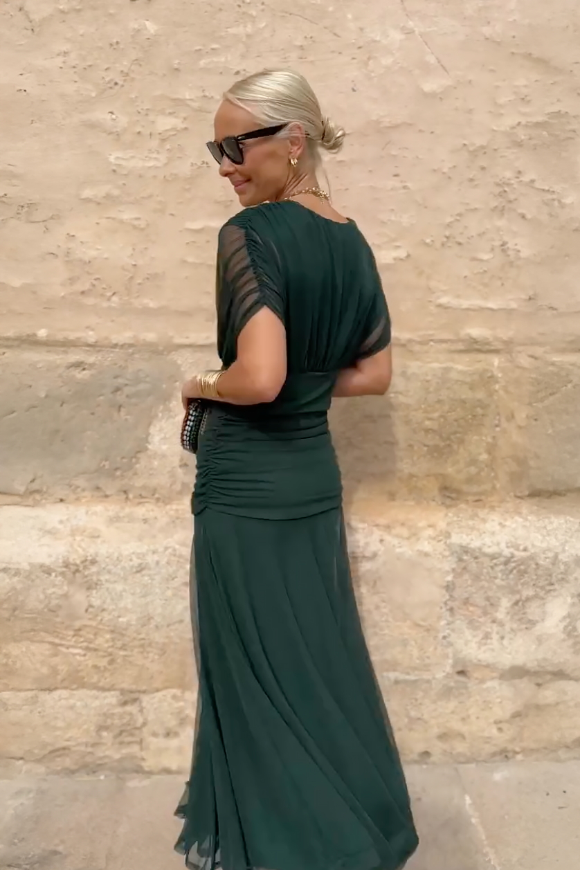 Back view of ruched waist detail on green mesh maxi dress