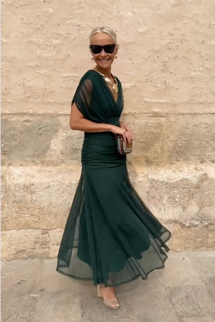 Full-length view of forest green V-neck maxi dress with flowing skirt