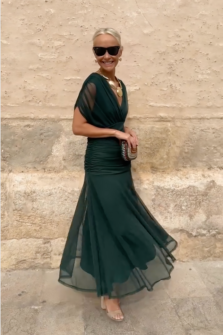 Full-length view of forest green V-neck maxi dress with flowing skirt