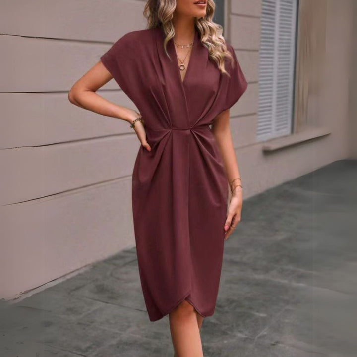 Burgundy draped midi dress with V-neck and cap sleeves, styled outdoors
