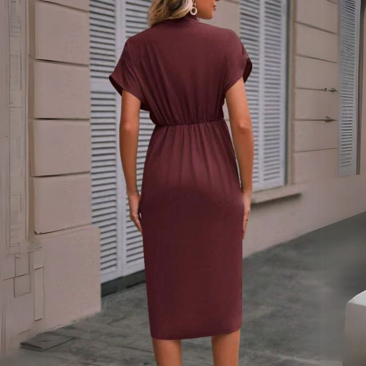 Rear view of burgundy wrap-style midi dress showing cinched waist detail