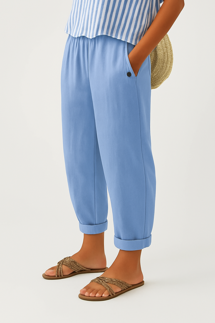 Sky blue cropped trousers featuring turn-up hem and relaxed tapered cut