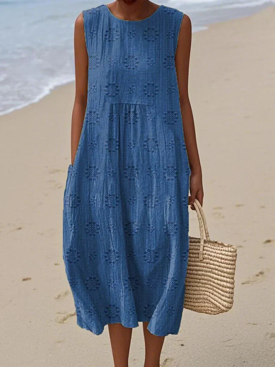 Blue sleeveless midi dress featuring embroidered floral pattern and pockets
