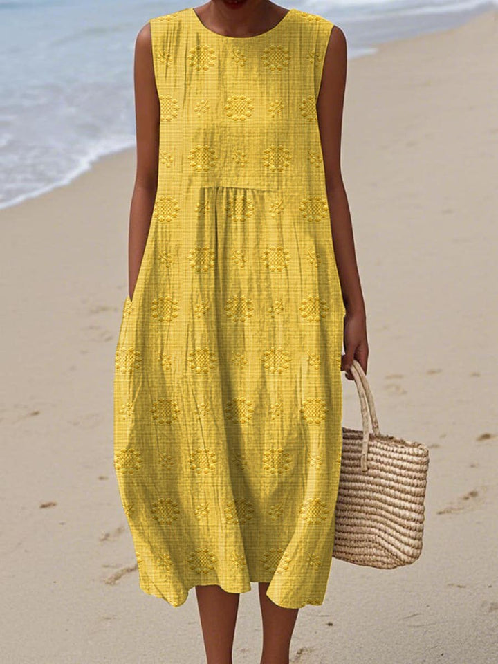 Yellow sleeveless midi dress with embroidered floral detail and side pockets