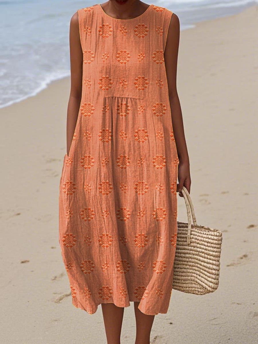 Orange sleeveless midi dress featuring embroidered floral pattern and pockets
