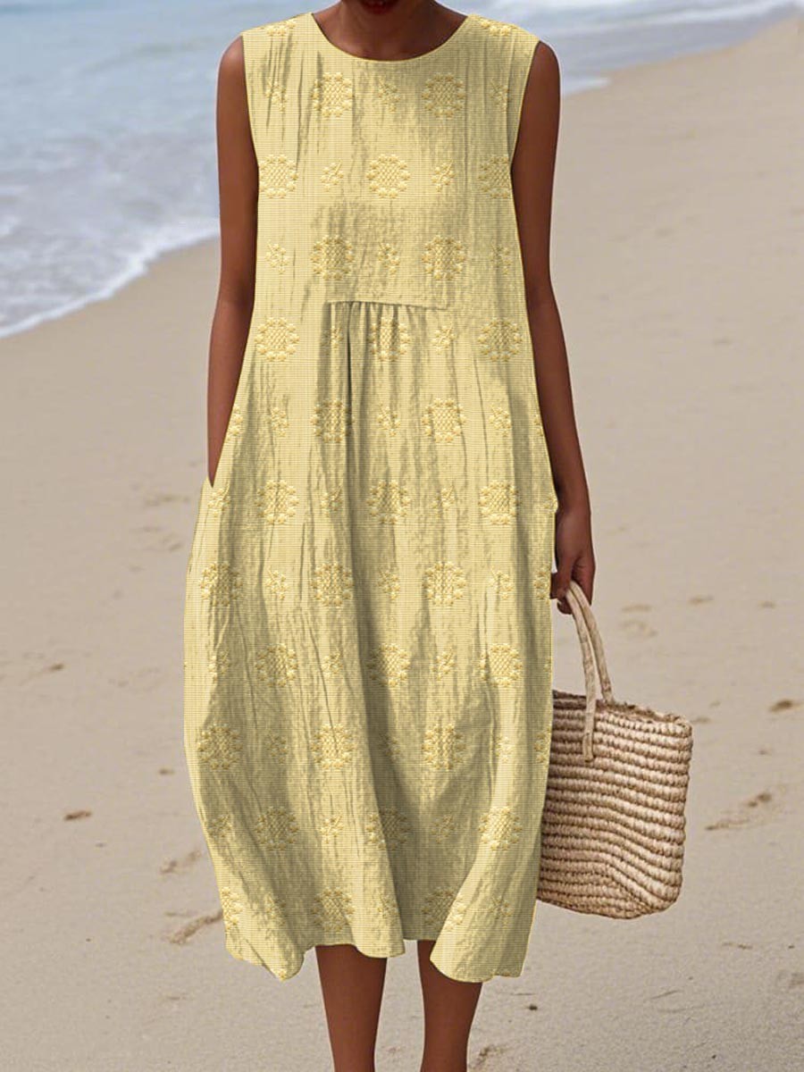 Pale yellow sleeveless midi dress with embroidered floral detailing and pockets