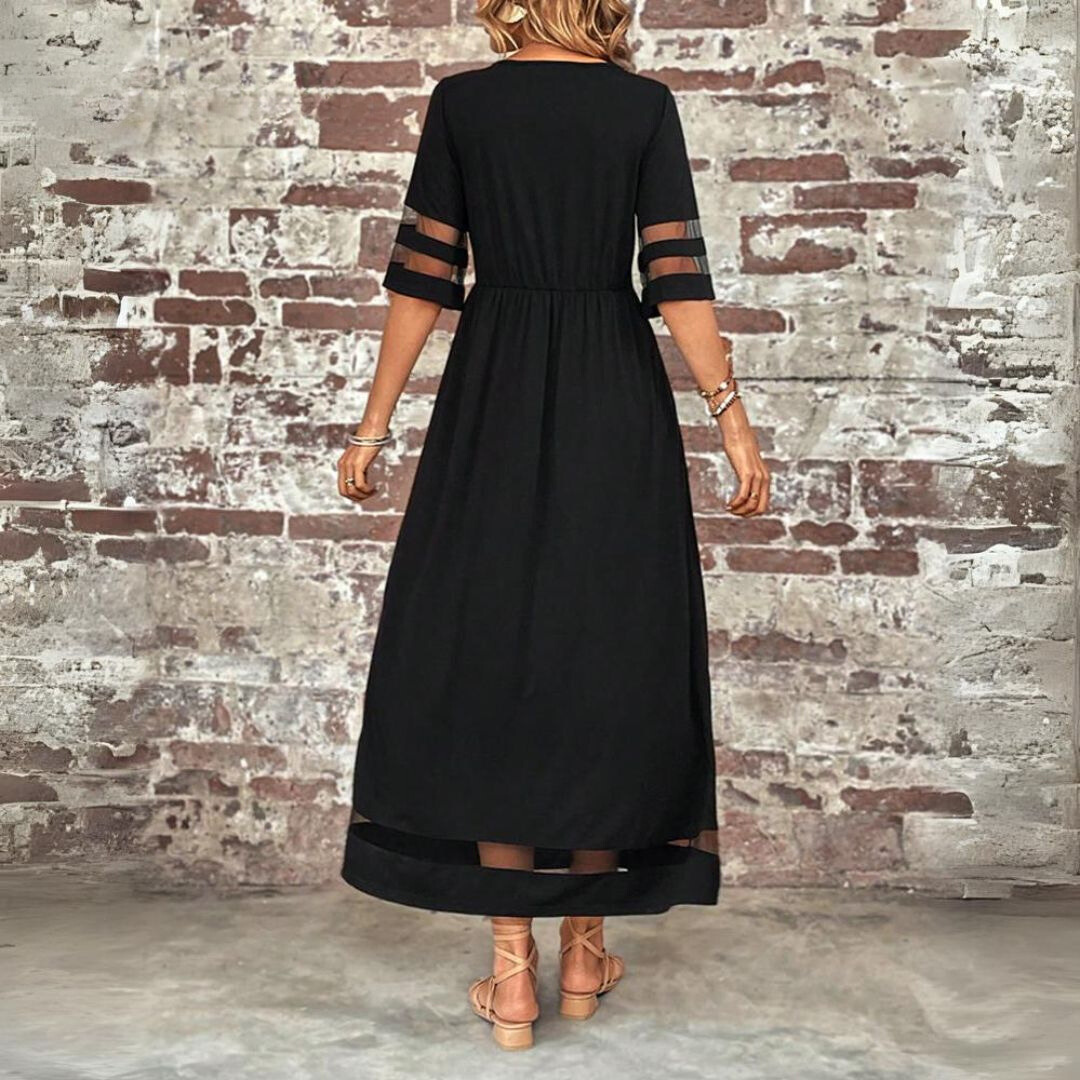 Black maxi dress with mesh panelled sleeves and flared skirt, shown from behind
