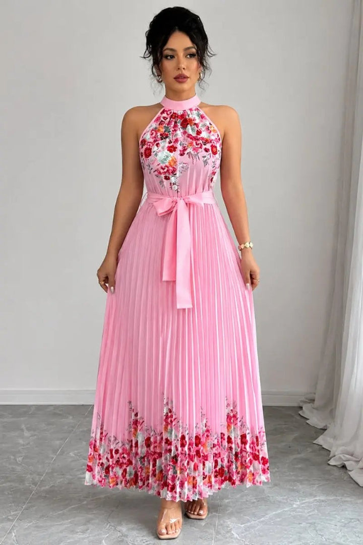 Pink halter-neck maxi dress with floral hem print and pleated skirt