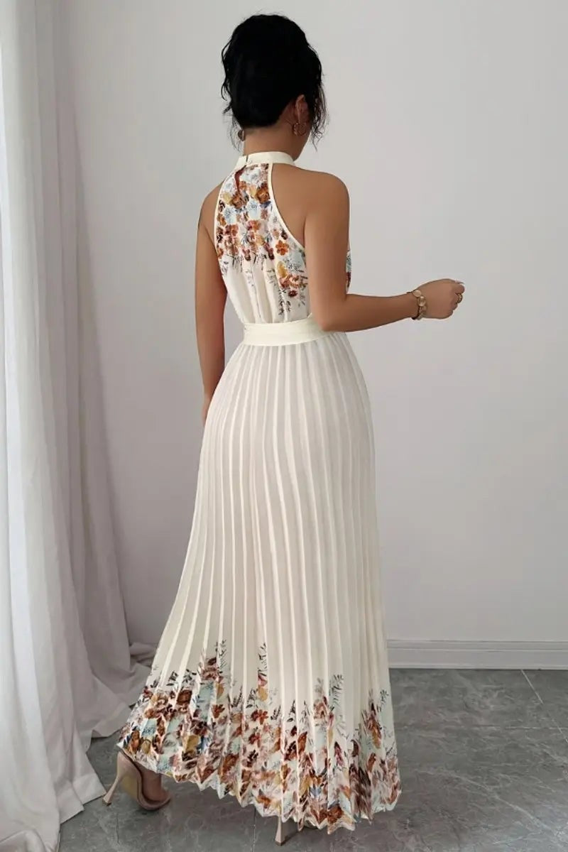 Rear view of cream pleated halter maxi dress with floral hem detail