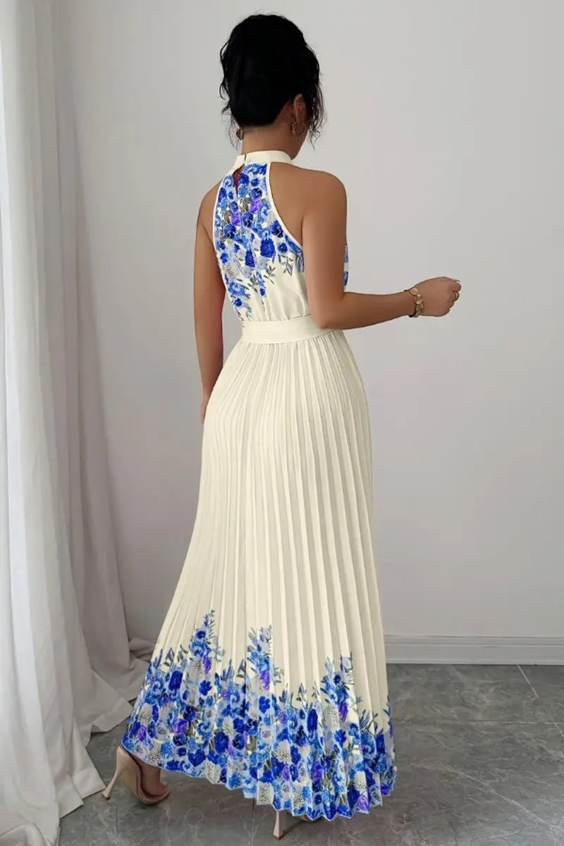 Back view of ivory pleated halter dress with blue floral hem accent