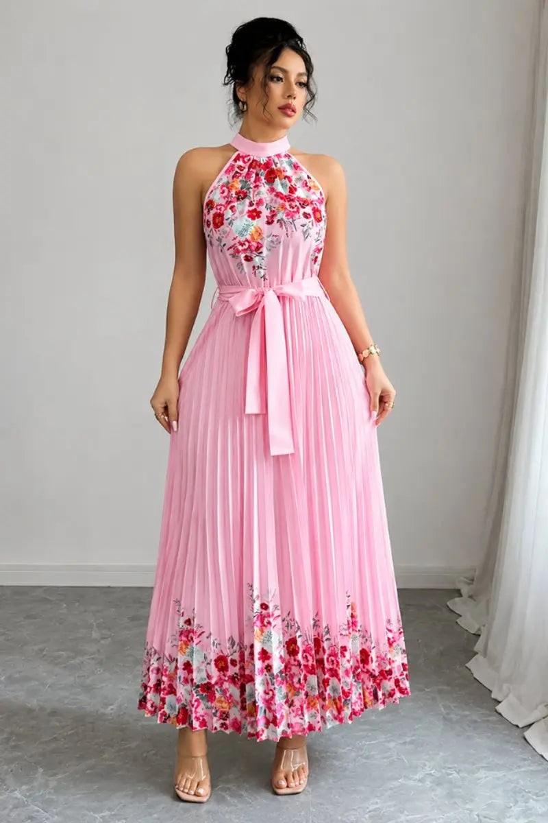 Pink pleated halter maxi dress featuring floral border and waist tie