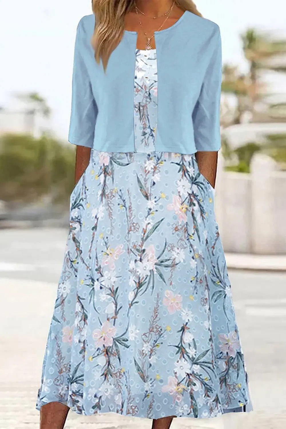 Pale blue floral midi dress paired with contrasting cropped jacket, worn outdoors