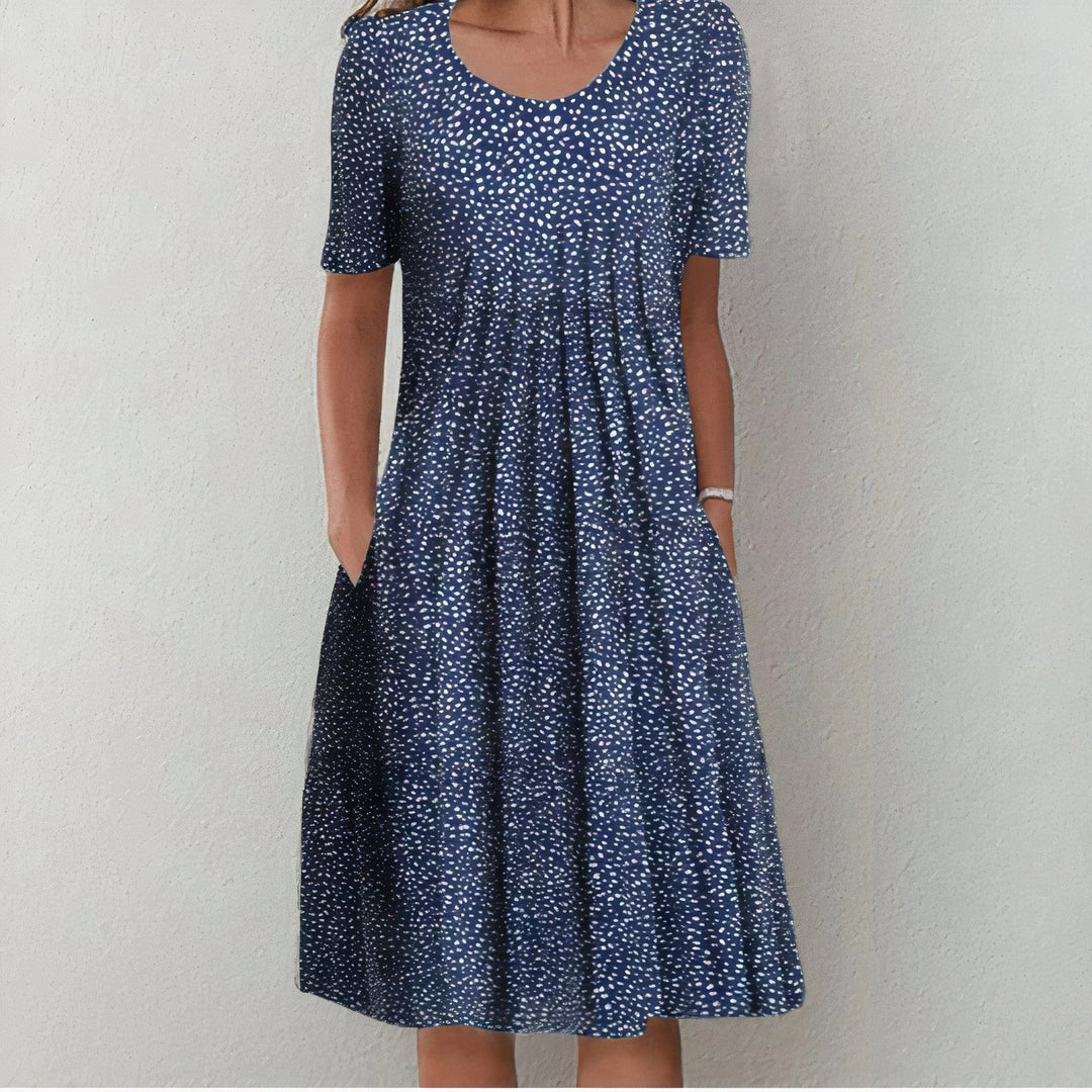 Navy midi dress with scattered white polka dot print and pockets
