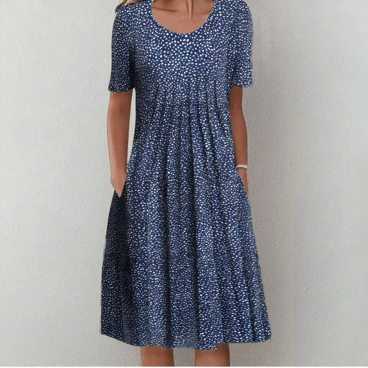 Navy midi dress with scattered white polka dot print and pockets