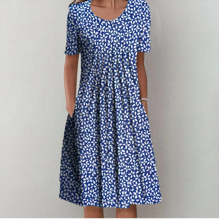 Navy blue midi dress with white floral pattern and pleated neckline