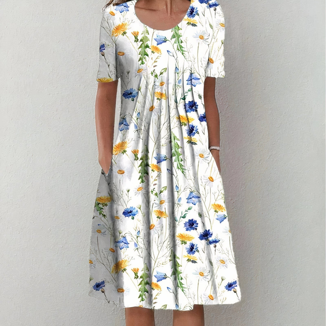 White midi dress with blue and yellow wildflower print and pockets