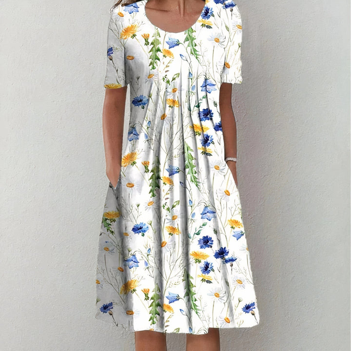 White midi dress with blue and yellow wildflower print and pockets
