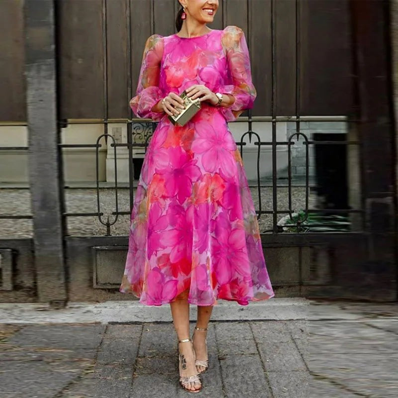 Pink floral midi dress with puff sleeves, worn with strappy heeled sandals