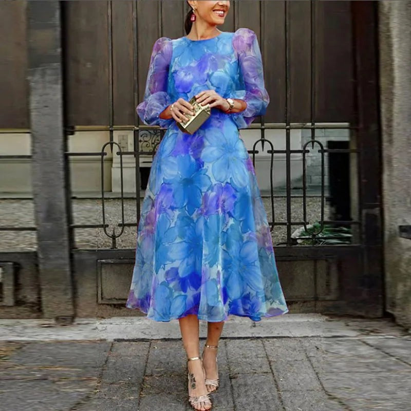 Blue floral midi dress featuring puff sleeves and a round neckline