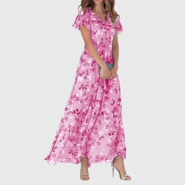 Pink floral print maxi dress with ruffled sleeves and flowing silhouette