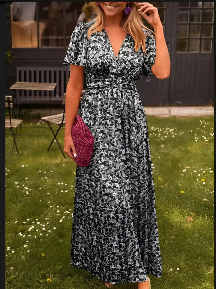 Monochrome abstract print maxi dress with flutter sleeves and V-neckline, close-up view