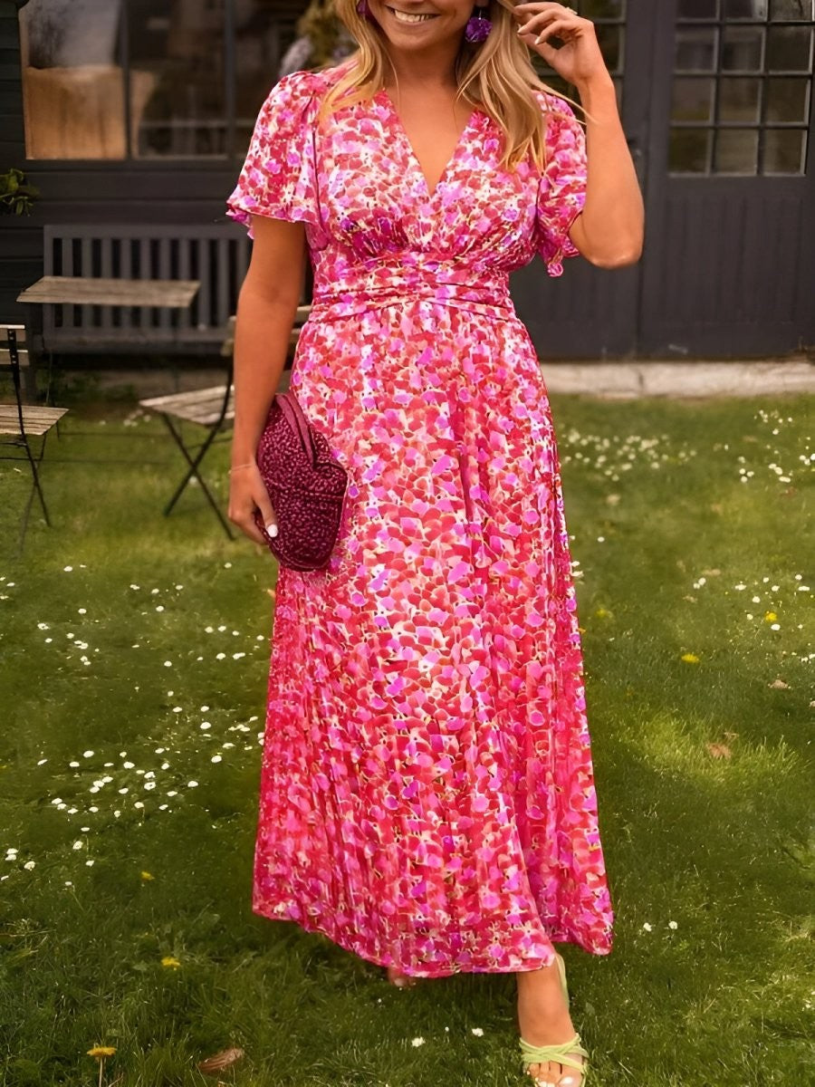 Pink floral maxi dress with V-neckline and flutter sleeves, close-up front view