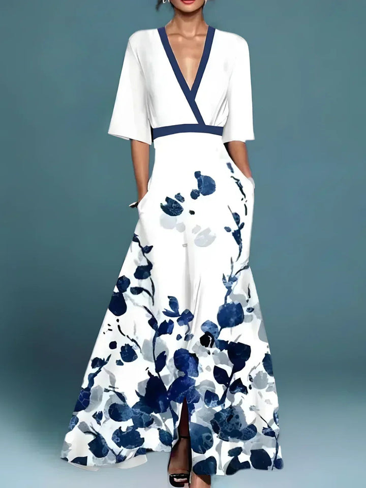 White maxi dress featuring navy floral pattern and contrast V-neckline
