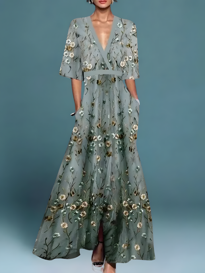 Sage green maxi dress with delicate floral embroidery and flowing skirt