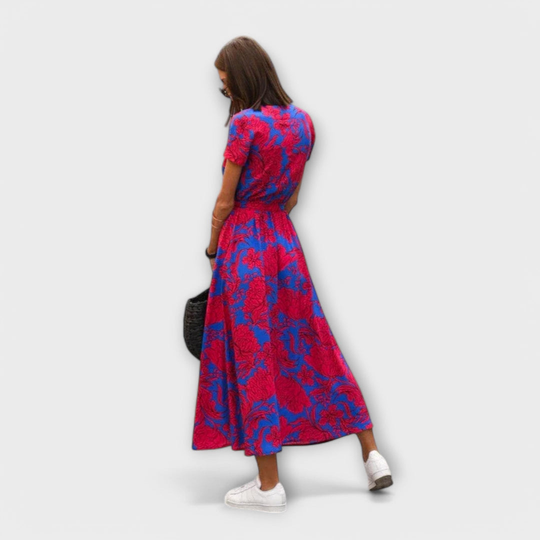Rear view of pink and blue floral wrap dress with tied waist belt
