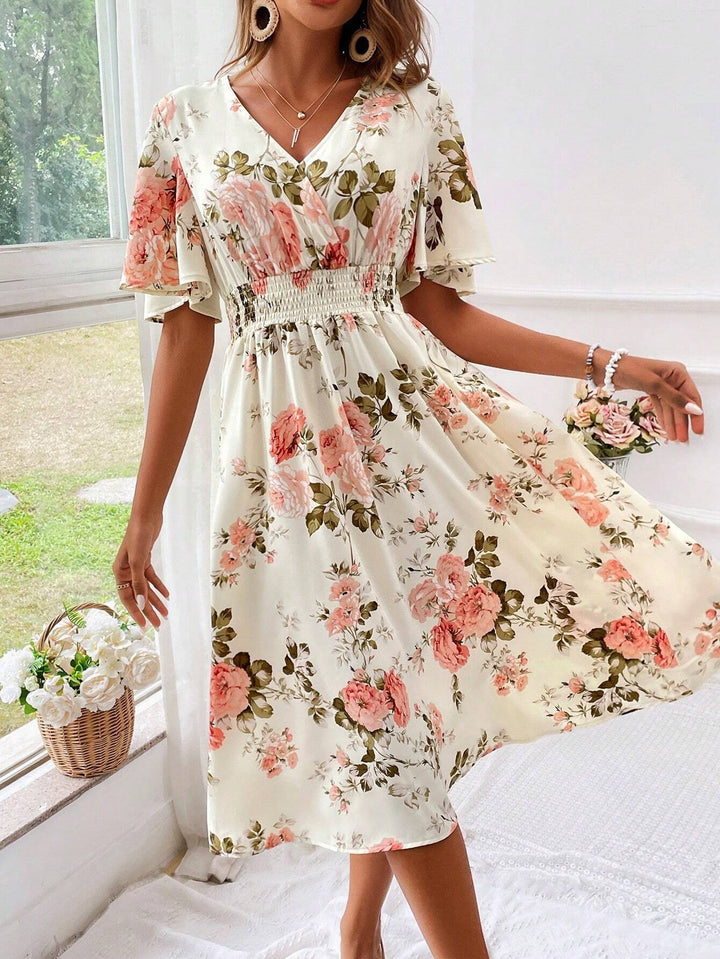 Cream floral midi dress featuring wrap V-neckline and elasticated waist detail